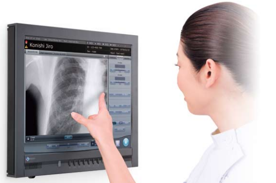 A woman using a digital radiographic plate — there are a few differences between plates.